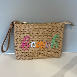 Beach purse with wrist strap.